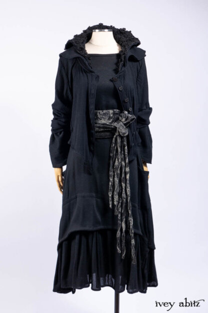 Limited Edition Coulson Cardigan in Signature Black Ribbed Knit; Blanchefleur Dress in Mansard Roof Washed Weave; Cilla Slip Frock in Signature Black Ribbed Knit; Porte Cochere Sash in Mansard Roof Washed Floral Woolen Weave.